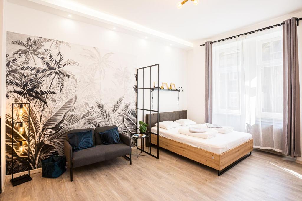 a bedroom with a bed and a mural of palm trees at Gaia Studio House in Budapest