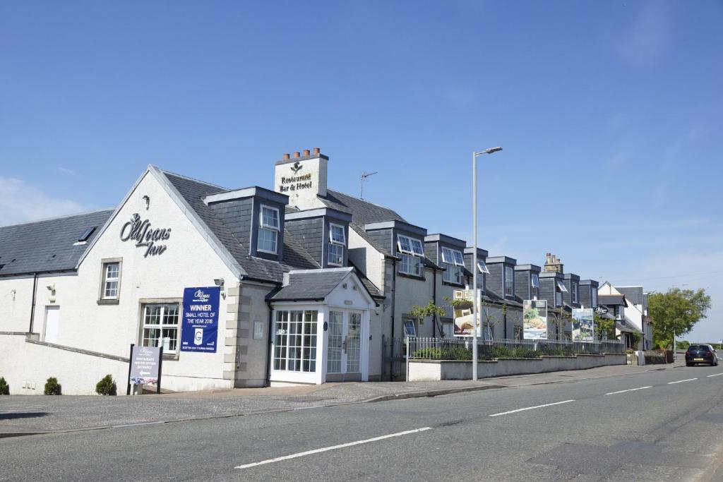 a white building on the side of a street at Old Loans Inn in Troon