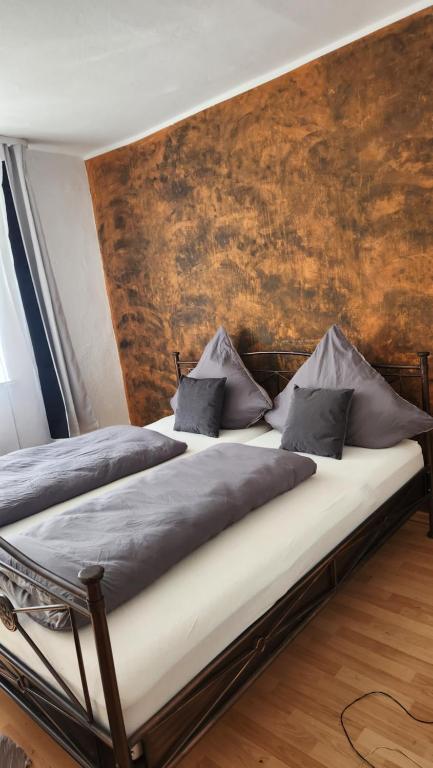 a bedroom with two beds in a room with a wall at Hemma 4 U , 3 Zimmer Wohnung in Kempten