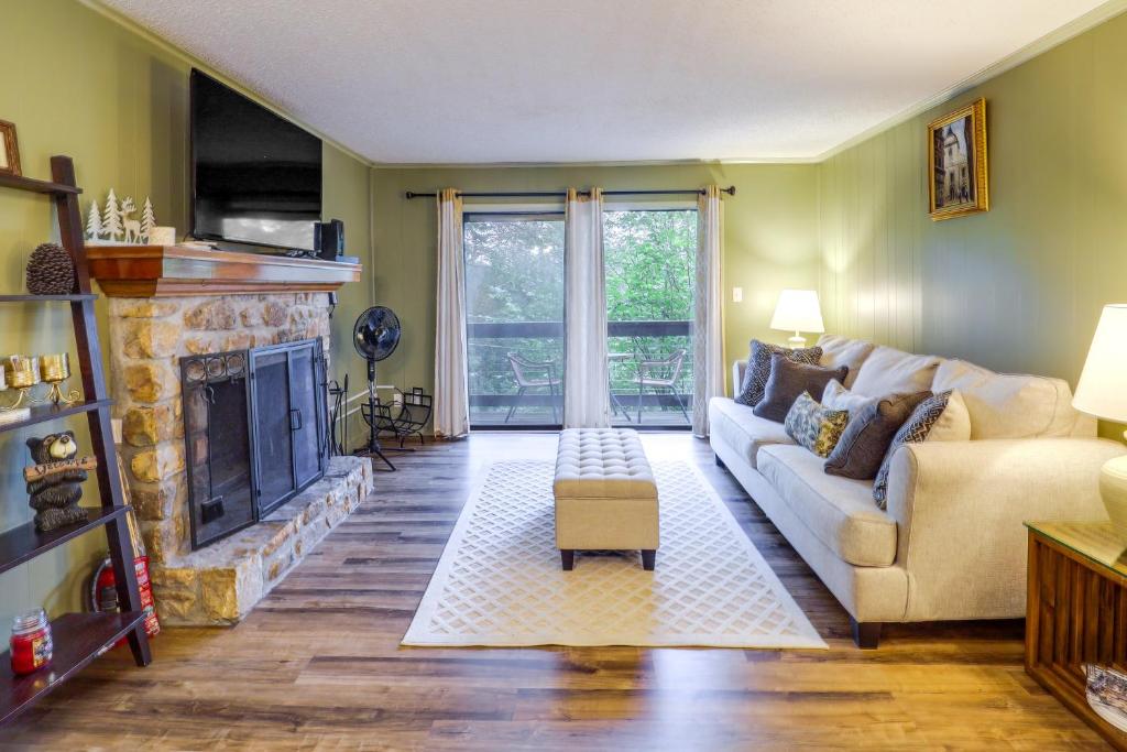 a living room with a couch and a fireplace at Walk to Slopes! Pet-Friendly Beech Mtn Condo in Beech Mountain