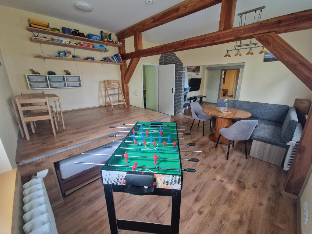 a living room with a ping pong table in it at Familienfreundliche Fewo MV Malchin in Malchin