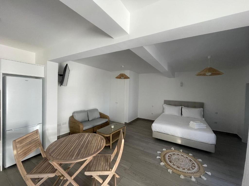 a bedroom with a bed and a table and a chair at Tides proprety - Low tide in Paul do Mar