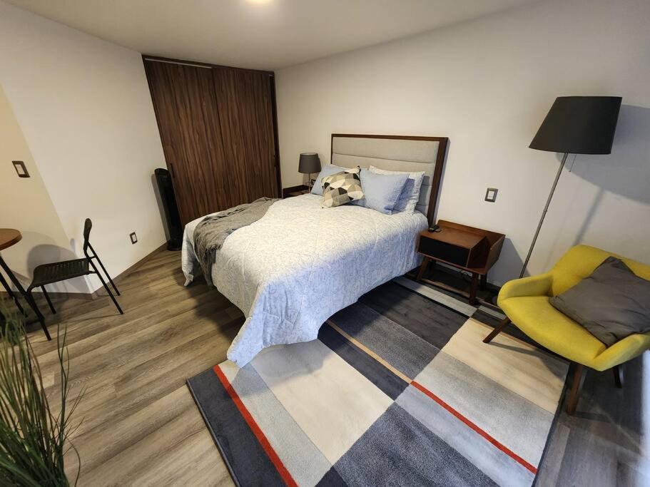 a bedroom with a dog laying on a bed at Asombroso Loft Moderno Con Excelente Ubicación in Mexico City