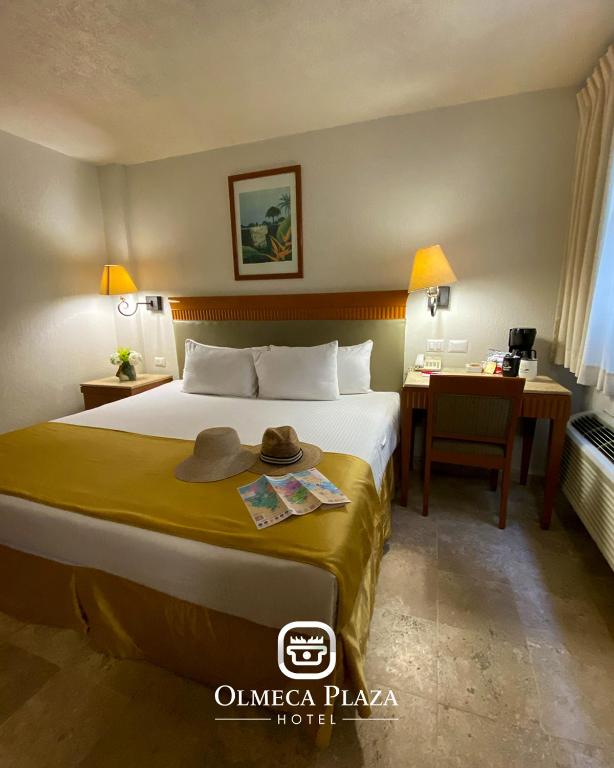 Postel nebo postele na pokoji v ubytování Hotel Olmeca Plaza
