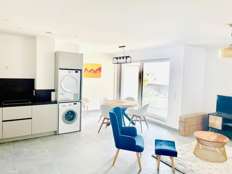 Il comprend une cuisine et un salon avec une table et des chaises. dans l'établissement Brand New 3 bedrooms with Terrace and Parking - 142-92, à Luxembourg