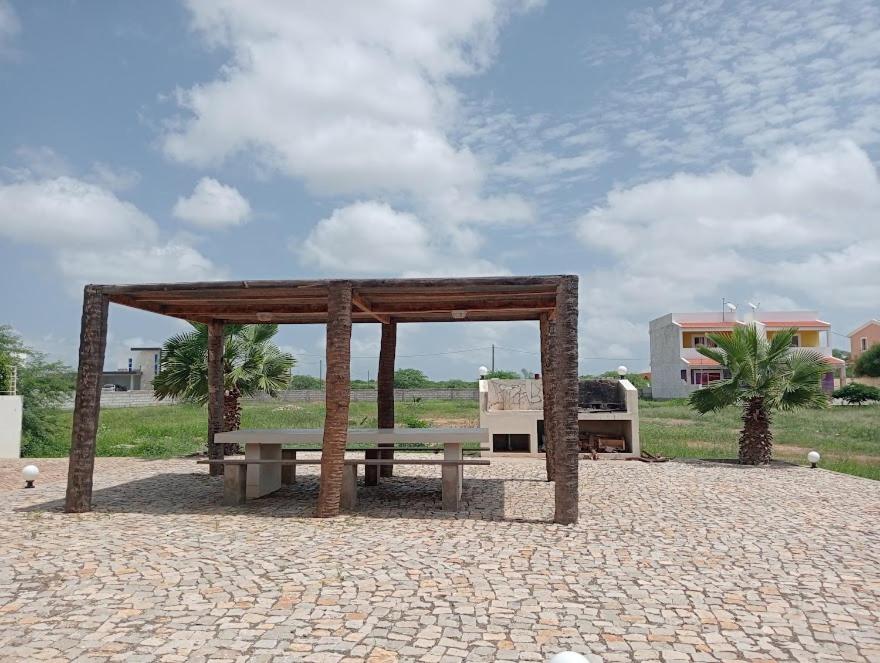 a pavilion with a bench on a brick ground at VIOLA in Vila do Porto