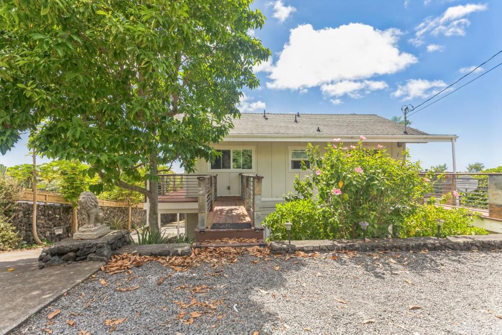 a house with a tree in front of it at Cozy Sunset Views with Lanai - Close to Beach home in Kailua-Kona