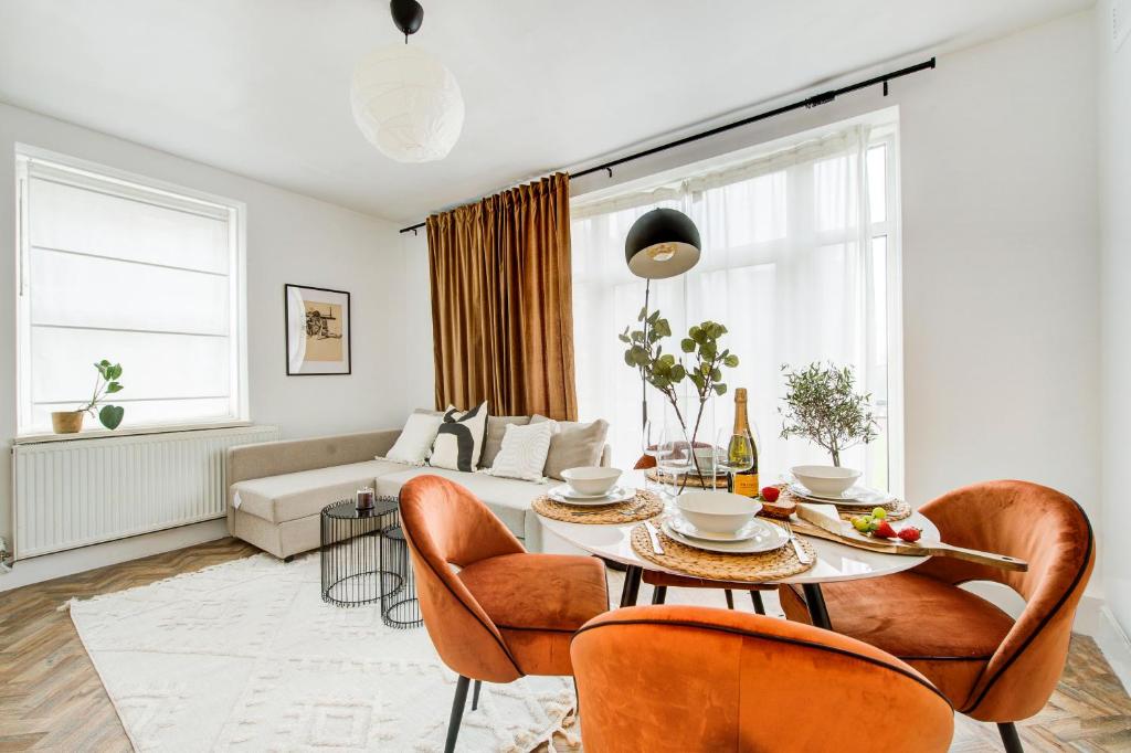 sala de estar con mesa, sillas y sofá en Beautiful 2bedroom close to Brick Lane, en Londres