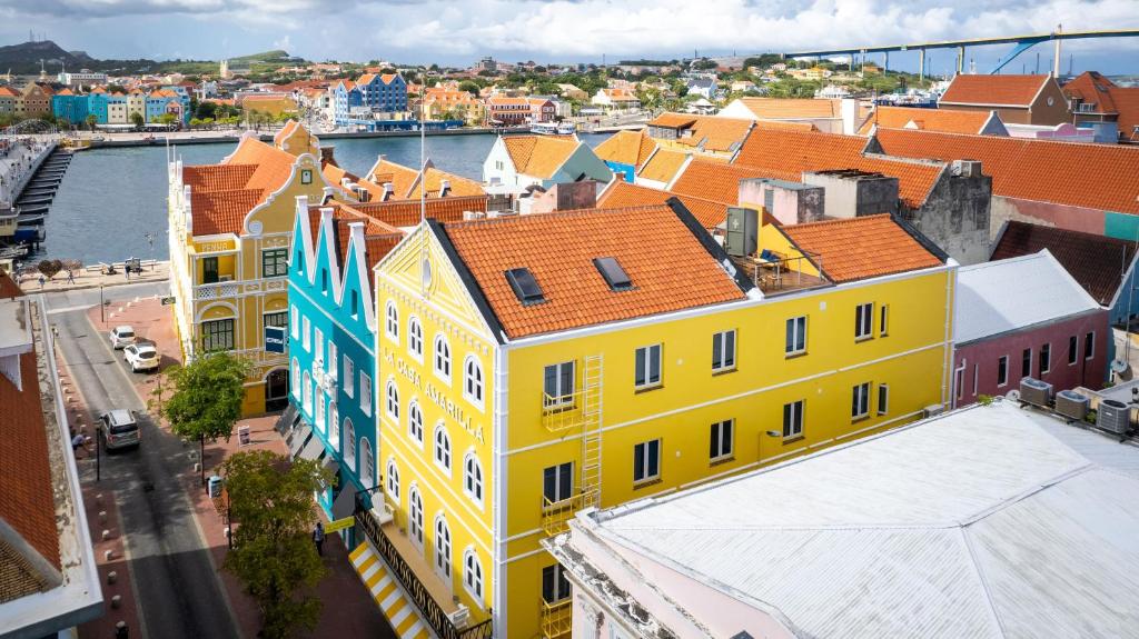 an overhead view of a city with yellow buildings at La Casa Amarilla Apartments in Willemstad
