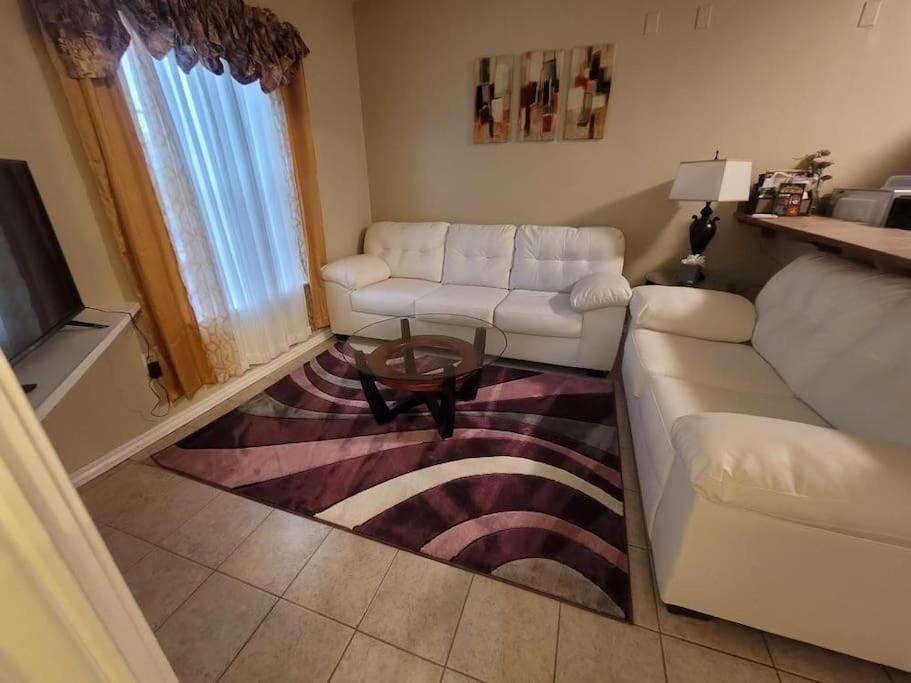 a living room with a white couch and a table at Cozy 3Bdr 2Bth 1st floor Unit in New Orleans