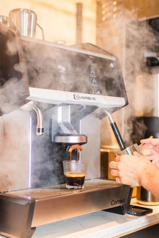 a person is making a drink in a coffee machine at Margaritaville Hotel San Diego Gaslamp Quarter in San Diego
