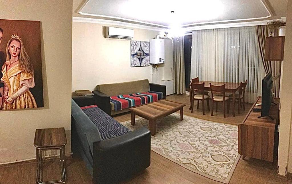 a living room with a couch and a dining room at Апартаменты для семьи (№4) in Yalova