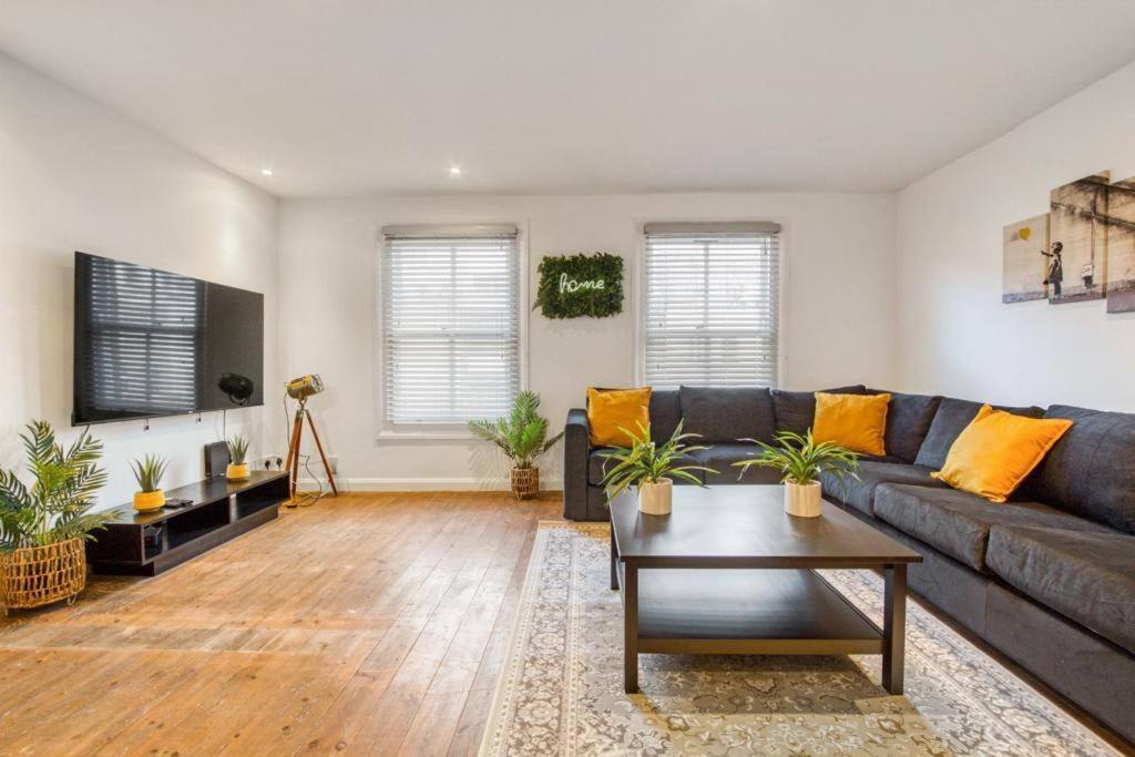 a living room with a couch and a table at Apartment in Shoreditch/ Old St in London