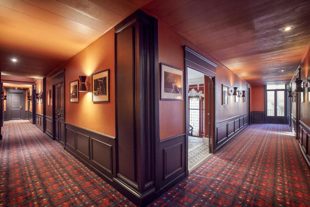 an empty hallway in a building with orange walls at Grand Hôtel du Midi Montpellier - Opéra Comédie in Montpellier