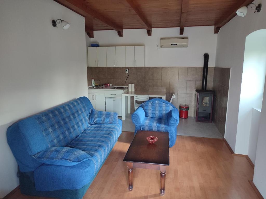 a living room with a blue couch and a table at Talija in Kotor