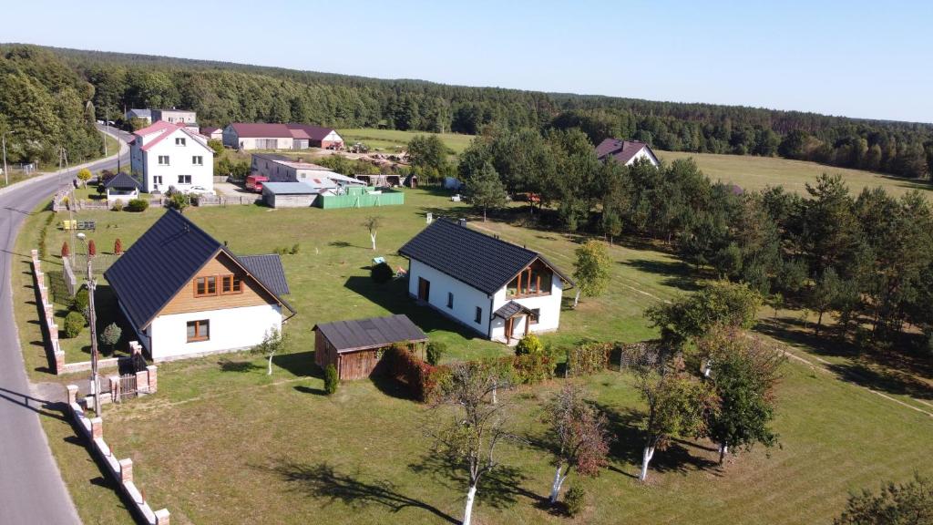 an aerial view of a house on a green field at Domek całoroczny na Kaszubach in Lipusz
