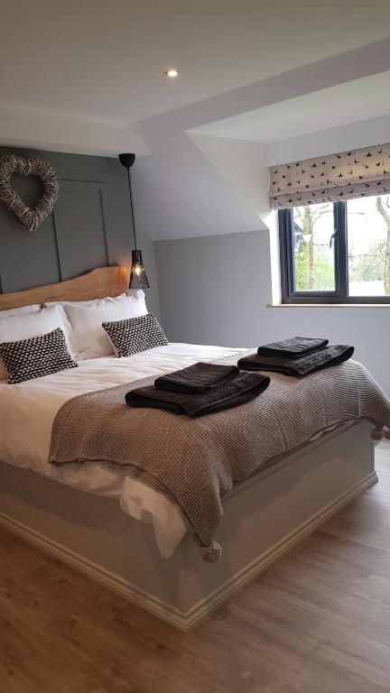 a bedroom with a large bed with towels on it at Appleton House in Thornbury