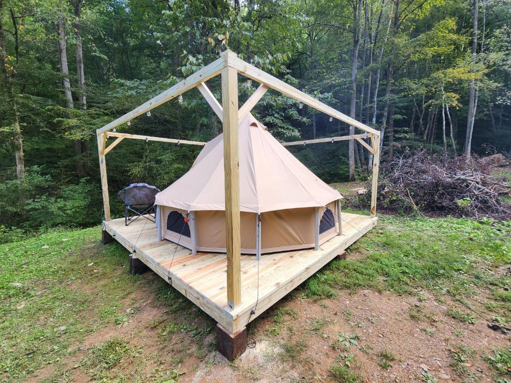 a tent on a wooden platform in a field at Glamping tent in Butler