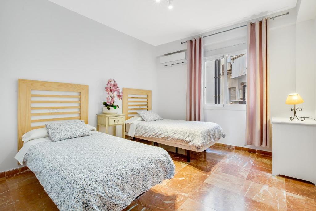 Posteľ alebo postele v izbe v ubytovaní Apt Alameda de Colon Solo Familias