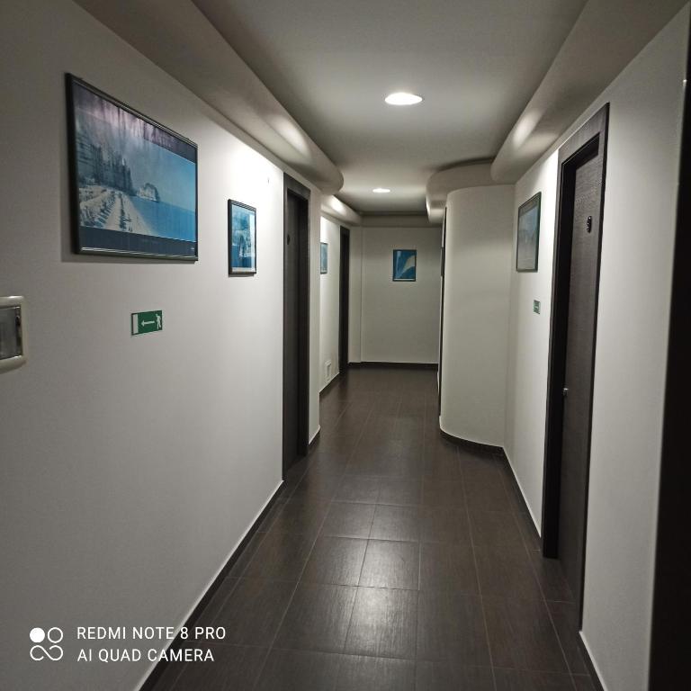 a hallway in a building with a tv on the wall at Residence Porto Ulisse in Parghelia