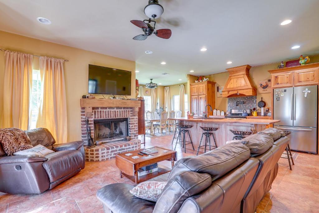 a living room with a couch and a fireplace at Peaceful Haynesville Vacation Rental with Yard! 