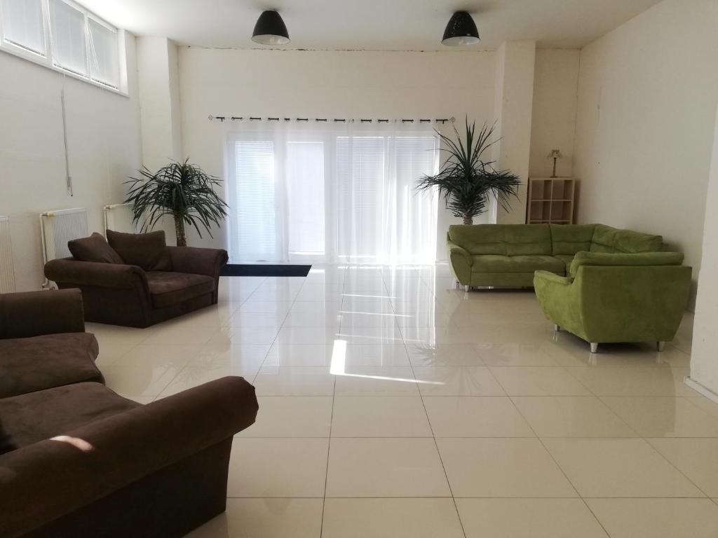 a large living room with couches and chairs at Guest House Factory in Malacky