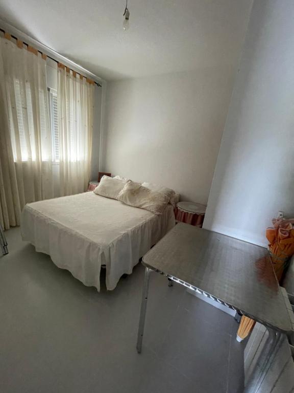 a bedroom with a bed and a table in it at Casa El Real de San Vicente in El Real de San Vicente