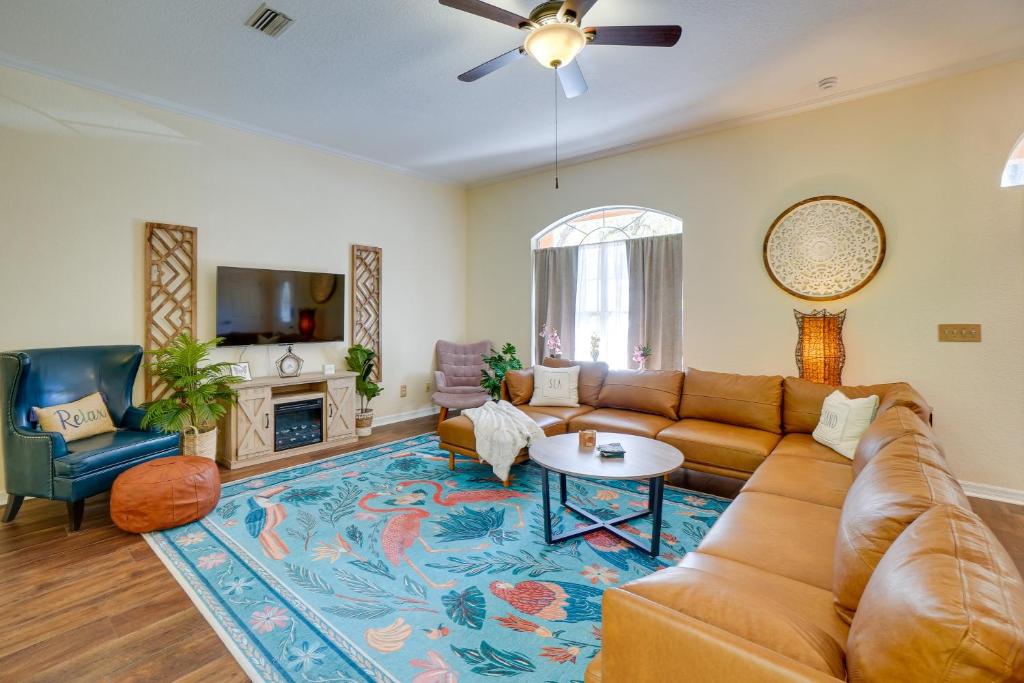 a living room with a couch and a table at Tarpon Springs Family Getaway with Patio and Hot Tub! in Tarpon Springs