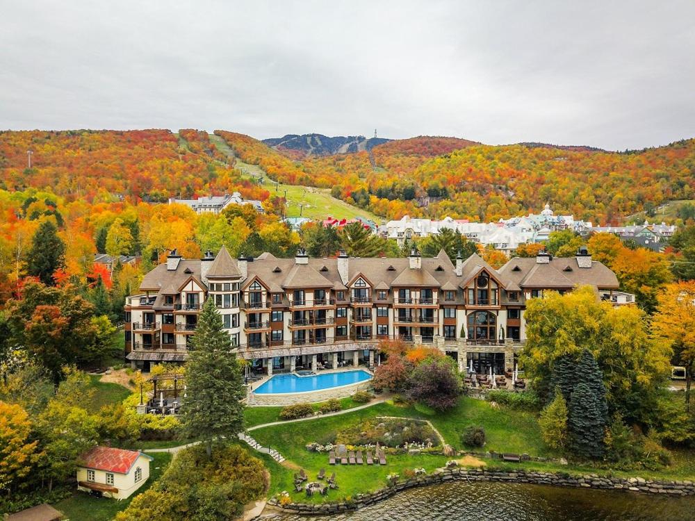 an aerial view of a large mansion with a pool at Hotel Quintessence in Mont-Tremblant