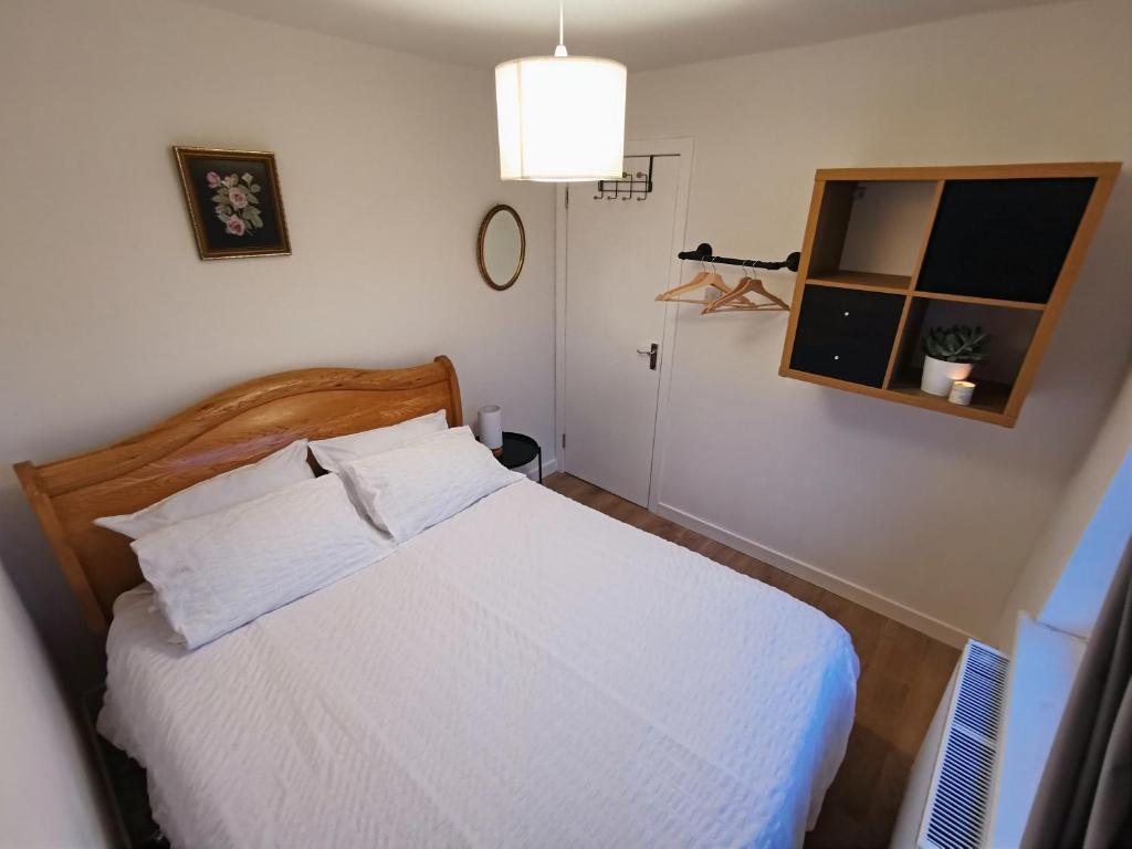 a bedroom with a white bed and a mirror at Peaceful house in the heart of Glasgow city, close to Queen Elizabeth Hospital and Govan subway, Free Private Parking in Glasgow