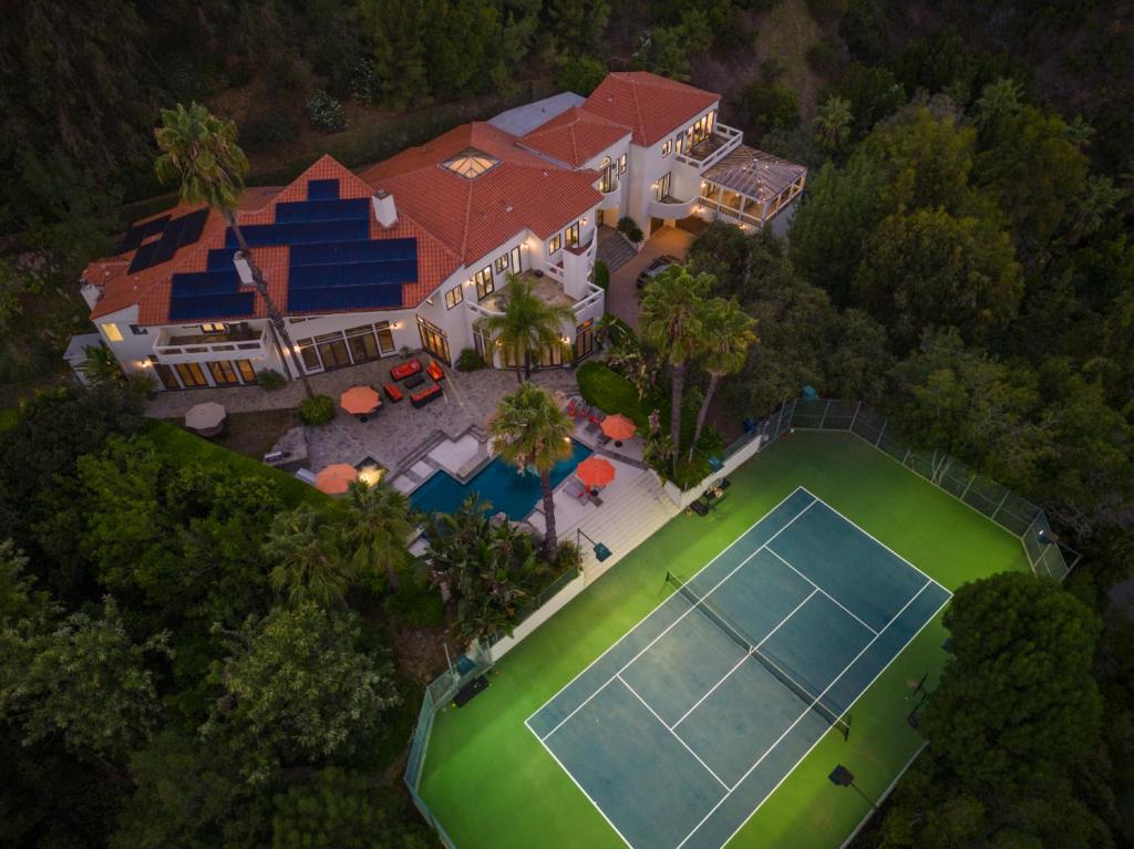 an overhead view of a large house with a tennis court at Anzio Estate in Los Angeles