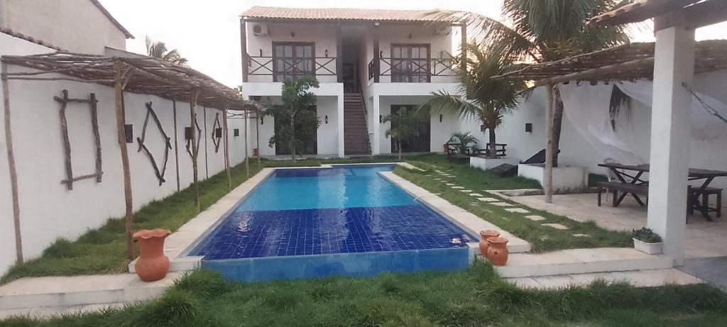 a swimming pool in front of a house at Casa Vila Prea Jericoacoara é logo ali in Prea