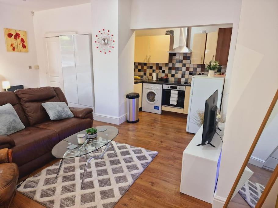 a living room with a couch and a coffee table at The Cosy Corner studio in Sheffield