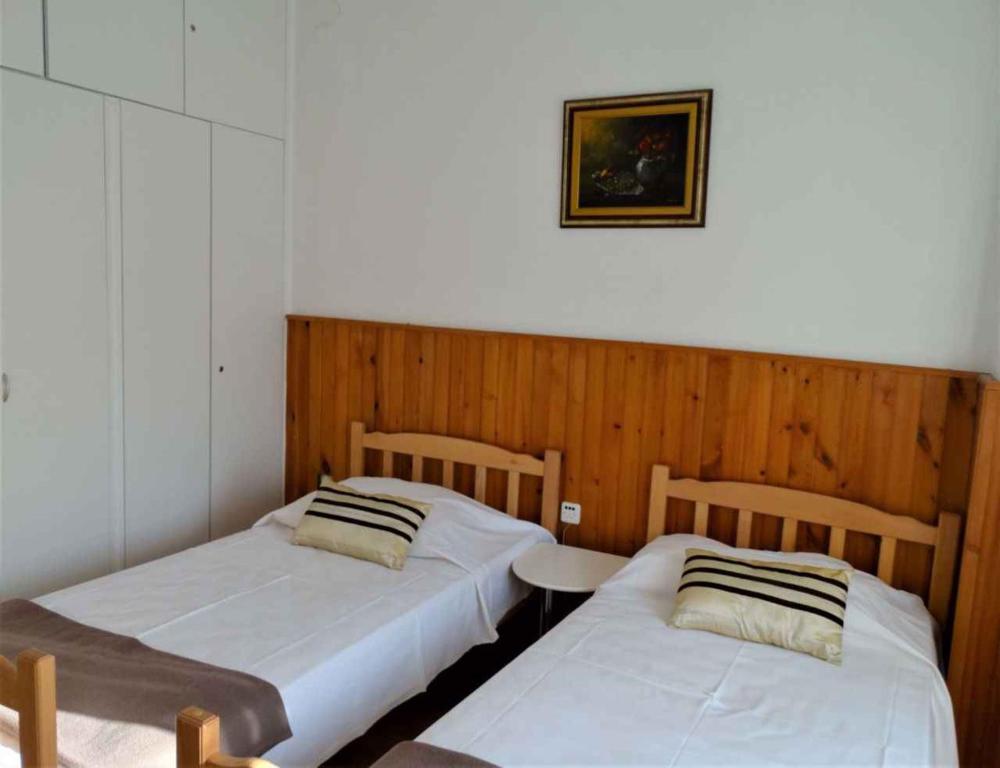 two beds in a room with a table and a picture at Apartments in Crikvenica 41681 in Crikvenica
