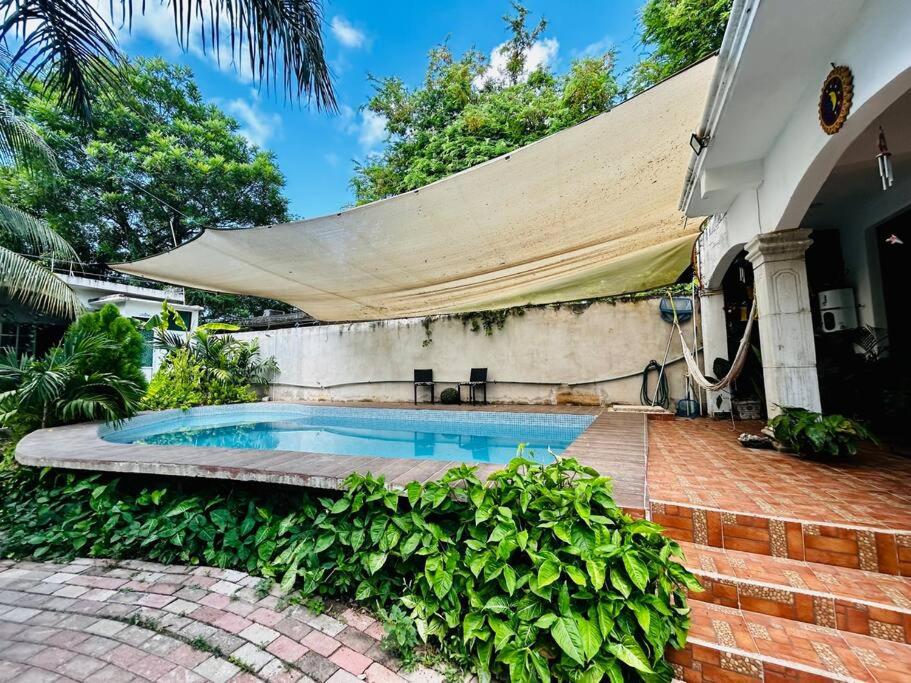 a swimming pool in the backyard of a house at Villa Los Duendes in Cancún