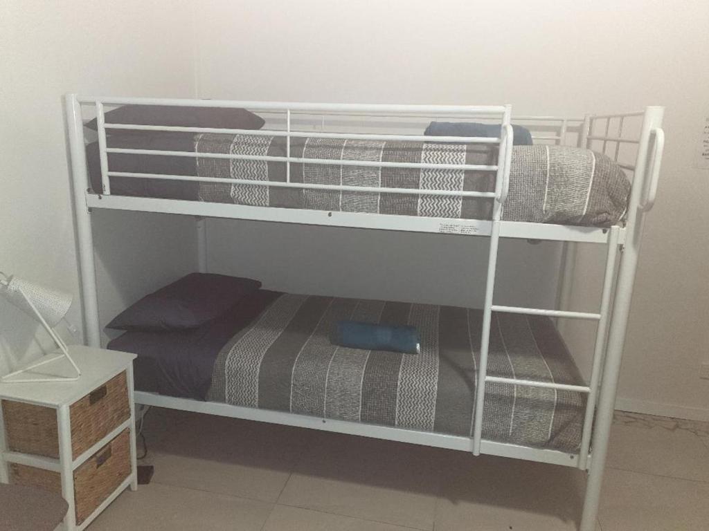 a couple of bunk beds in a room at Hostel-Style GUESTHOUSE - for 18-35yrs in Caloundra