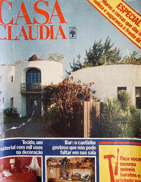 a magazine cover of a house with a building at CASA DE REVISTA em Cabo Frio in Cabo Frio