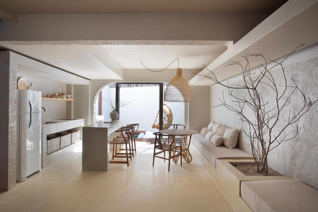 a kitchen and living room with a table and chairs at Kza Patacho in Pôrto de Pedras