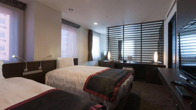 Postel nebo postele na pokoji v ubytování Onomichi Kokusai Hotel