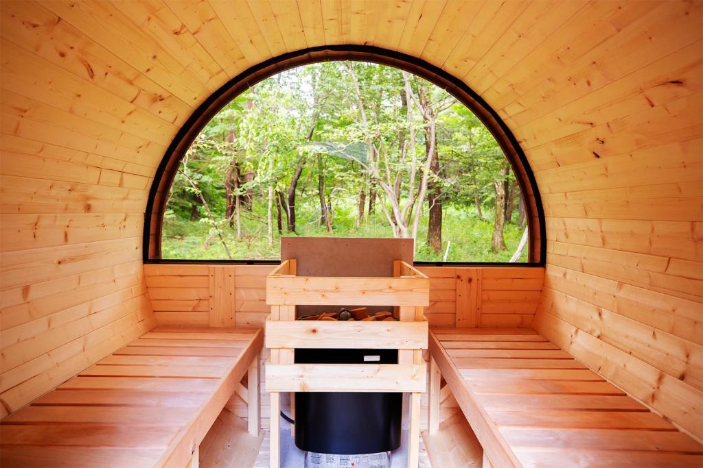 an inside view of a wooden cabin with a window at LEVATA Nasu バレルサウナ付きログハウス BBQ可 1棟貸切 6名様まで同料金 in Nasu