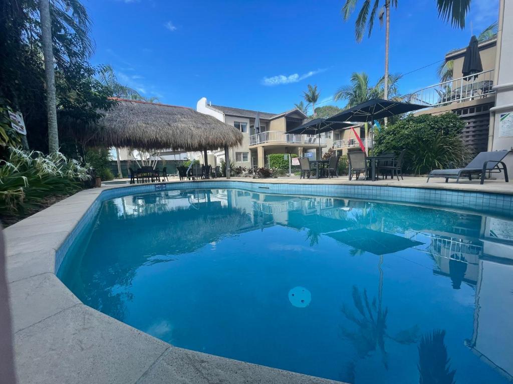 a swimming pool with blue water in a resort at Clearwater Noosa Resort in Noosaville