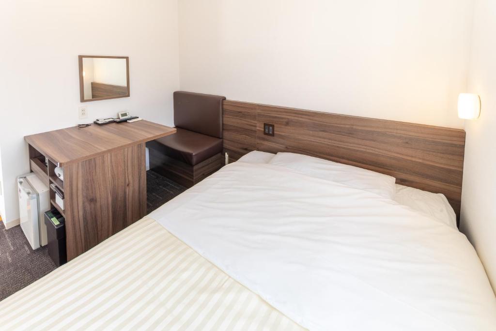 Postel nebo postele na pokoji v ubytování Super Hotel Tokyo JR Tachikawa Kitaguchi