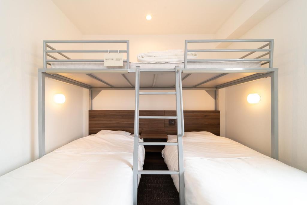 Postel nebo postele na pokoji v ubytování Super Hotel Tokyo JR Tachikawa Kitaguchi