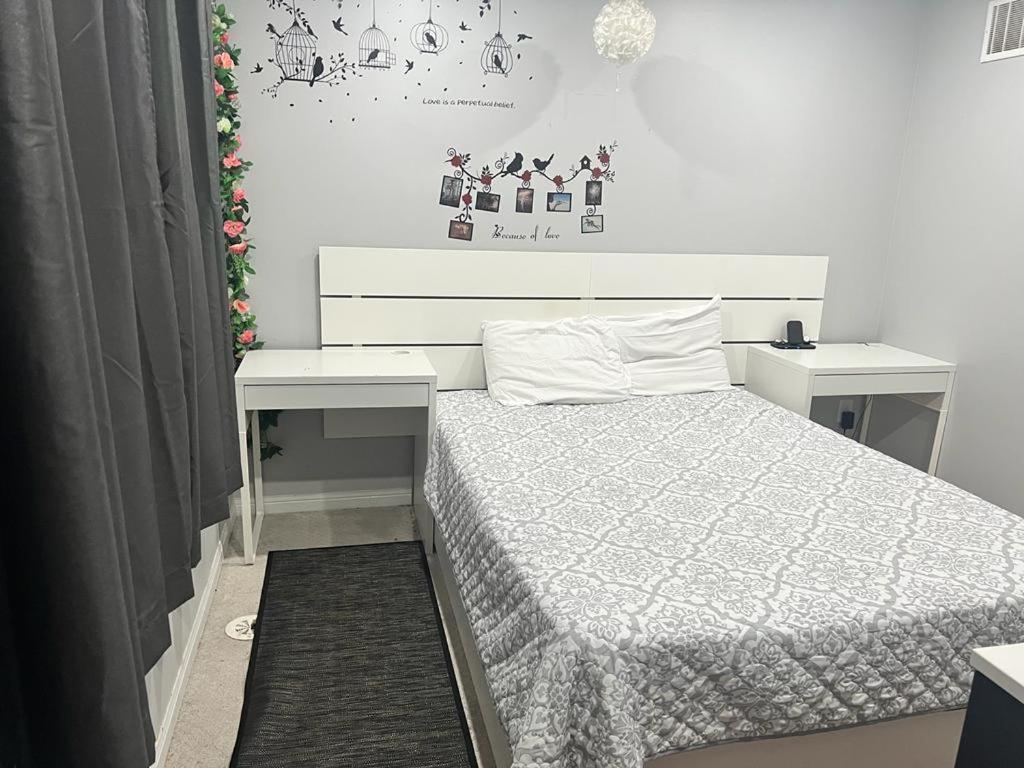 a white bedroom with a bed and a desk at Private, Secure, Immaculate & Cozy Room in Brampton
