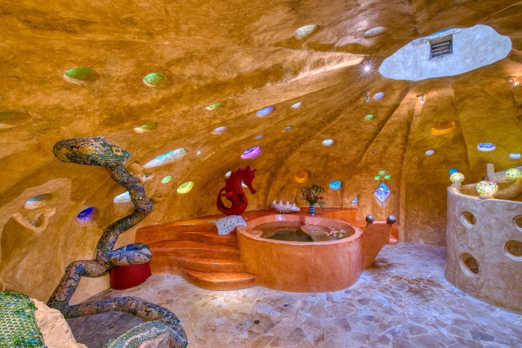 a painting of a room with a snake around a tub at Tree House Beachfront Lodge in Puerto Viejo