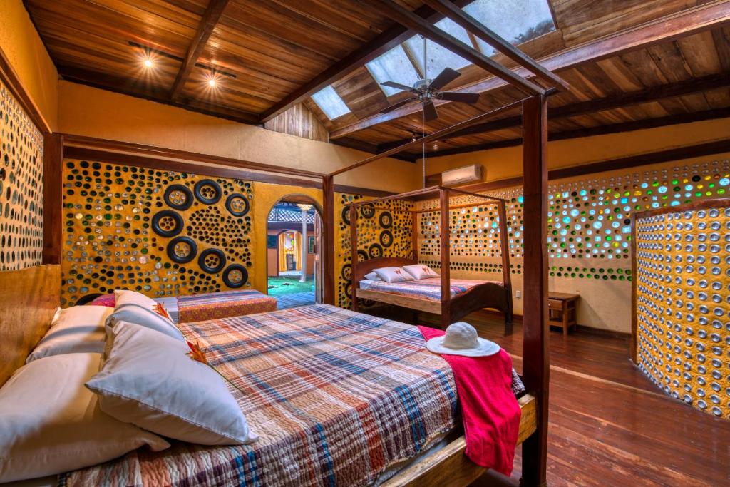 a bedroom with a bed in a room at Tree House Beachfront Lodge in Puerto Viejo