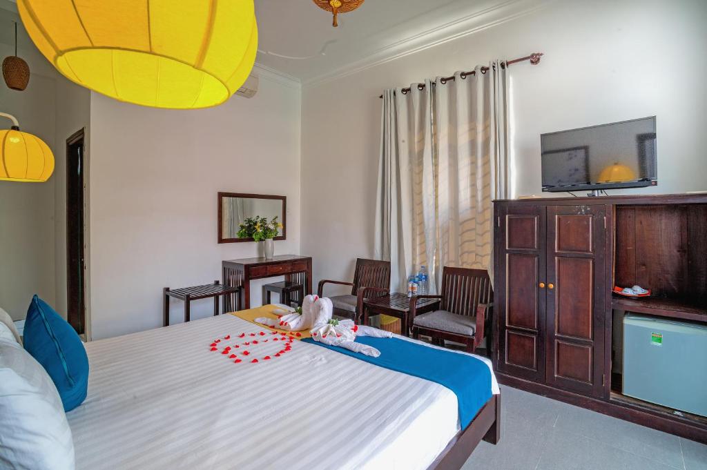 Postel nebo postele na pokoji v ubytování Hoi An Viet House Homestay