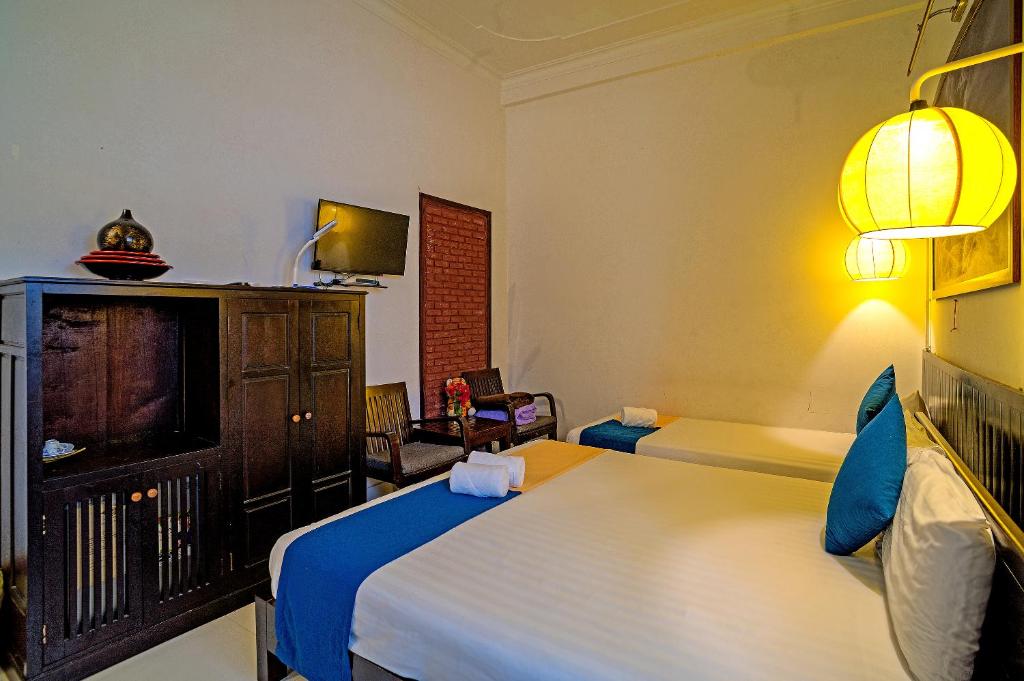 Postel nebo postele na pokoji v ubytování Hoi An Viet House Homestay