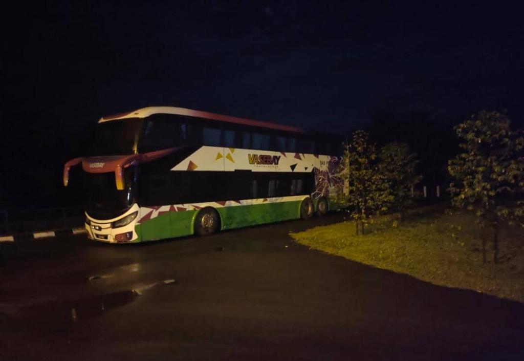 a bus parked on the side of a road at night at Homestay Sunnah & Event Space Islam Bayti Annubuwah 