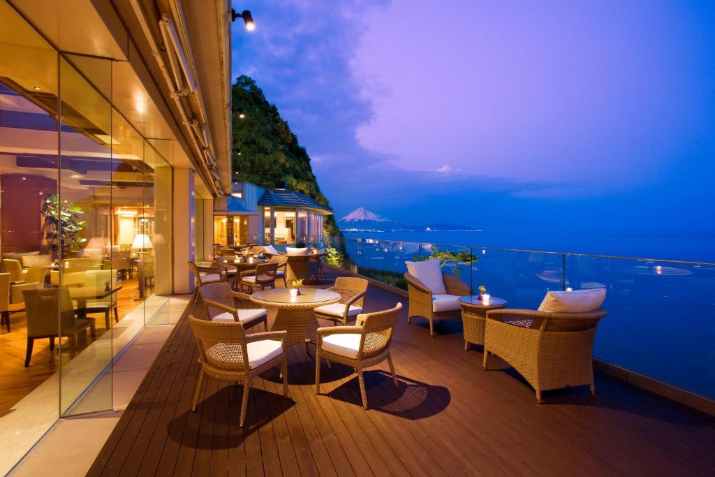 a restaurant with a view of the ocean at night at 焼津グランドホテル 